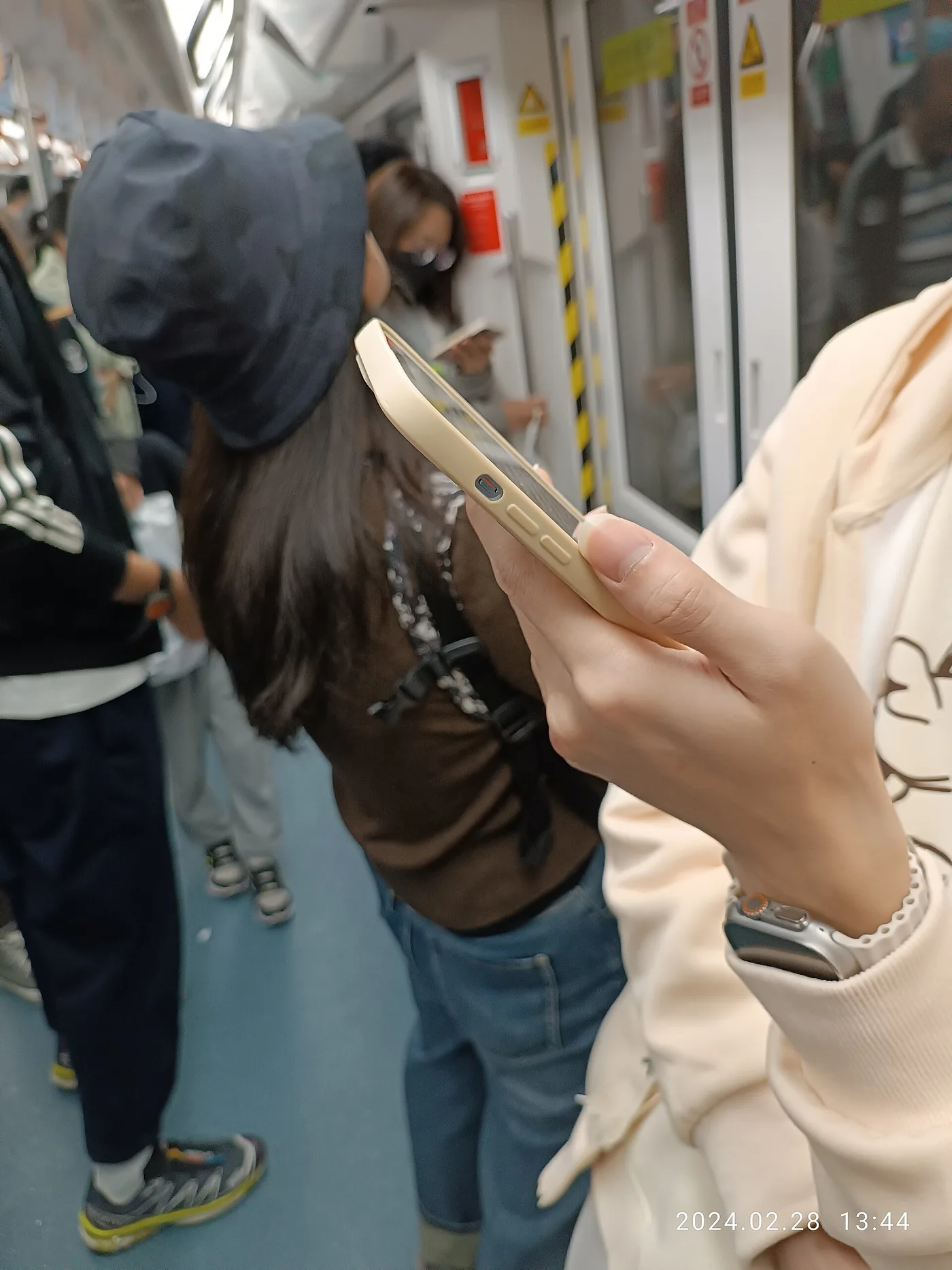 Passenger holding a smartphone on the Shenzhen Metro